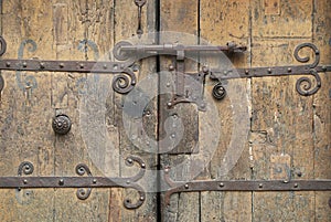 Old wooden gate with an ancient metal lock, Villefranche de Conflent, France