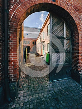 Old wooden gate with arch brickwork in Halmstad