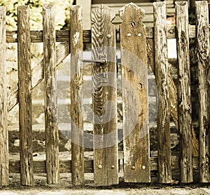 Old wooden gate with lock. Background. Detail of the old wooden door with a rusty metal lock.
