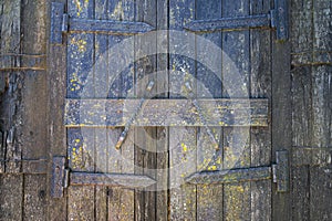 Old wooden gate with metal elements