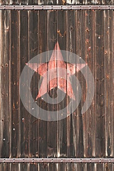 Old wooden gate with soviet star