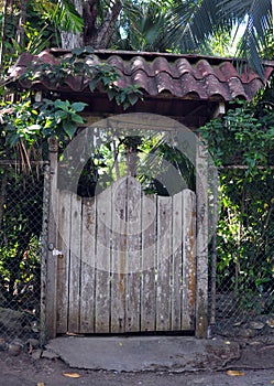 An Old Wooden Gate with a Tiled Roof