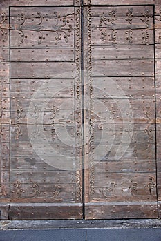 Old wooden gates lined with metal plates