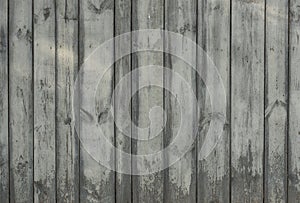 Old wooden gray fence for background from boards of different widths