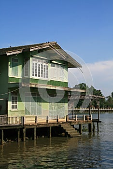 Old wooden green houses on the riverside