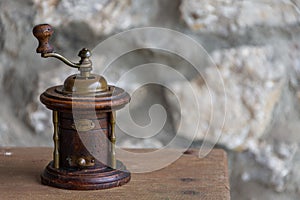 Old wooden grinder for pepper on wooden table