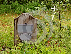 Old wooden headstone in a graveyard