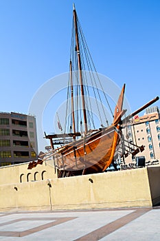 Old wooden boat called a Dhow outside the Dubai museum in UAE