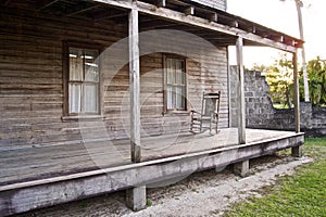 Old wooden home with rocking chair photo