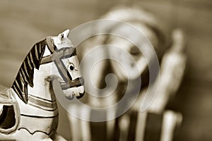 Old wooden horse and old marionette, in sepia toning