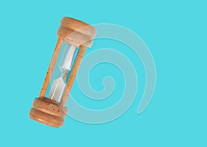 Old wooden hourglass isolated on Cyan background