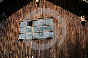 Old wooden house with a broken window