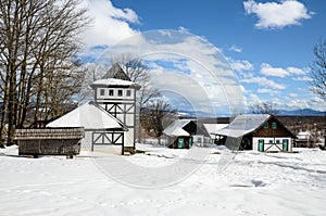 Old wooden house covered with the snow on mountain. Beautiful winter landscape in nature. Old farm buildings on cold day. Home