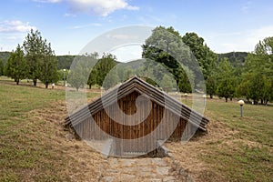 Old wooden house dug into the ground in Kliuch, Bulgaria