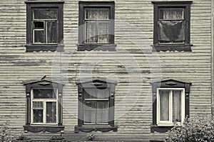 Old wooden house facade with six beautiful windows