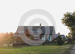 Old wooden house in village. Farmhouse in Belarus. View of rustic ethnic house on sunset. rural landscape