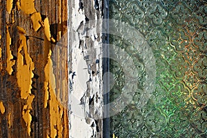 An old wooden house window with pealing off paint and old decorated window glass