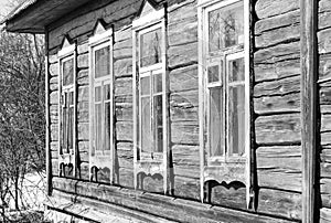 Old wooden house with windows in the garden black and white
