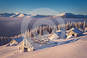 Old wooden houses in winter mountains