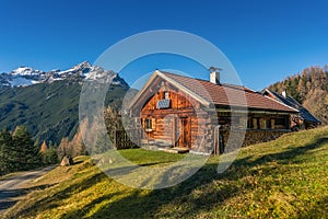Old wooden hut cabin in mountain alps photo