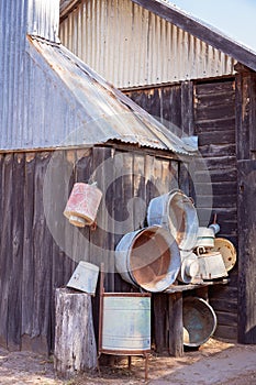 Old Wooden Hut With Vintage Containers On Wall