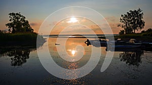 Old wooden jetty with boats (sunrise)