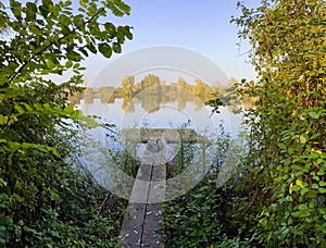 Old wooden jetty at a lake in autumn