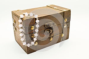 Old wooden jewelry chest with bracelet isolated on white background