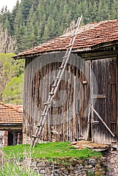 Old wooden ladder in front of historic barn