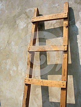 Old wooden ladder over the wall