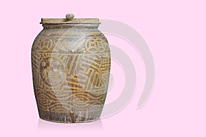 Old wooden lid on brown and yellow ceramic jar on pink background, object, decor, vintage, copy space