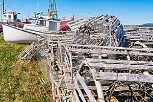 Old wooden lobster traps and fishing boats