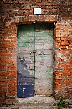 Old wooden locked door with peeling paint