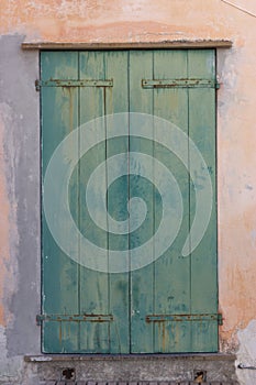 Old wooden locked door with peeling paint