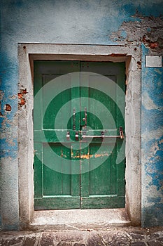 Old wooden locked green door