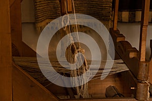 Old wooden loom in a rural house in Ukraine, an old spindle