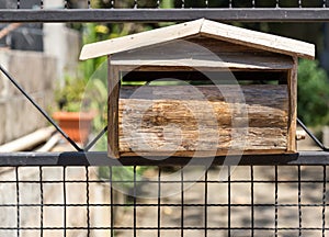 Old wooden mailbox on the iron fence