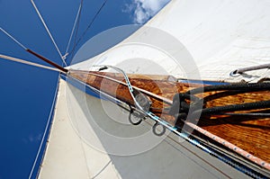 Old wooden mast with crosspieces, backstays,mainsail ,staysail