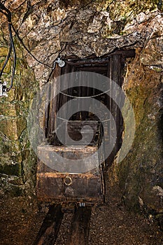 Old wooden mine chart in abandoned mine shaft with wooden timbering photo