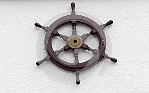 Old wooden naval sailing ship steering wheel photo