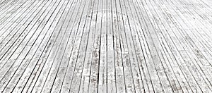 An old wooden pavement painted in white in a sunny day. Photo in perspective with selective focus