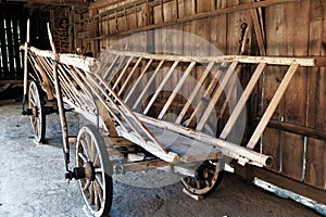 Old wooden peasant wagon parked in a shed