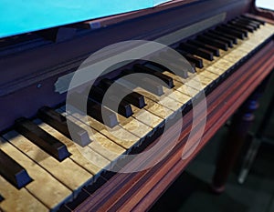 Old wooden piano with notoriously aged keys