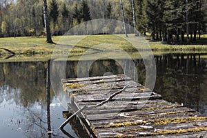 Old Wooden pier, footbridge on the lake in the sunrise.