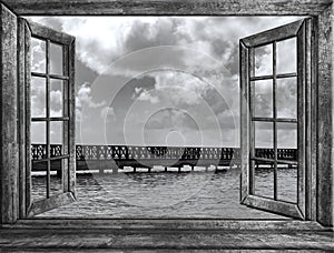 Old wooden pier goes to sea opened window