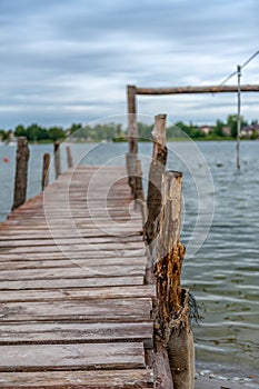 Old wooden pier with a lake in the background