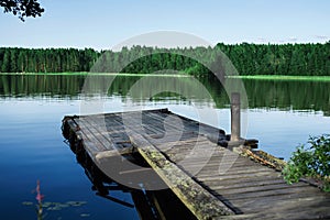 Old wooden pier on a lake at sunrise