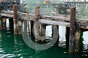 Old wooden pier with a lot of metal cages