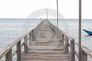 Old wooden pier on the sea. Old wooden jetty over the sea shore with copy space