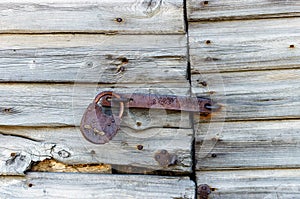 Close up of old wooden garage door with padlock